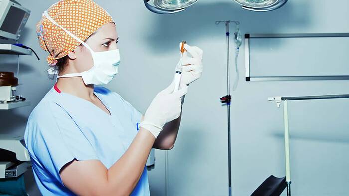 Nurse preparing syringe